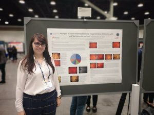 A photograph of Dr. Niamh Wynne presenting a poster on her ABCA4 Study at ARVO 2019